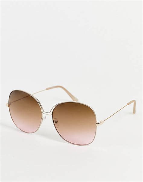 asos round sunglasses with metal bridge high bar &|Madein. oversized round sunglasses with metal bridge in brown.